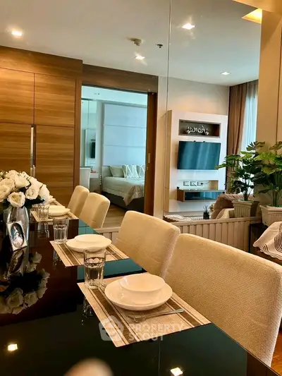 Luxurious modern living room with elegant dining area and cozy bedroom view.