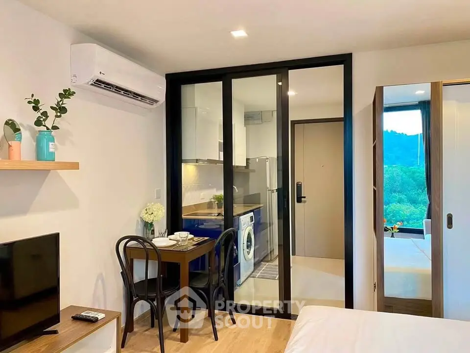 Modern studio apartment with open kitchen and scenic view