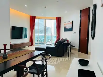 Modern living room with city view, stylish furniture, and large TV in luxury apartment.