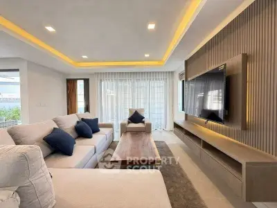 Spacious modern living room with elegant decor and large TV