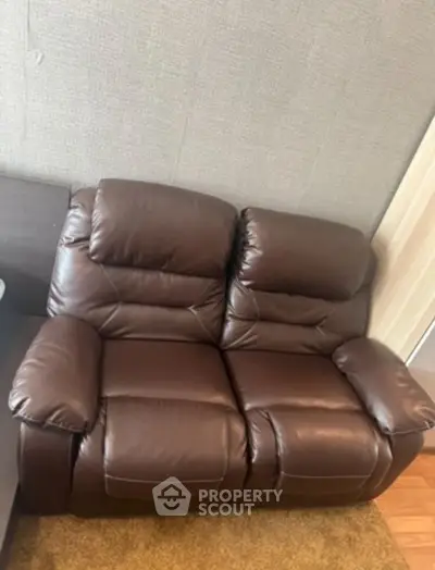 Luxurious brown leather recliner sofa in modern living room setting