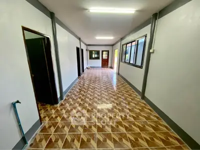 Spacious interior hallway with tiled flooring and multiple doorways