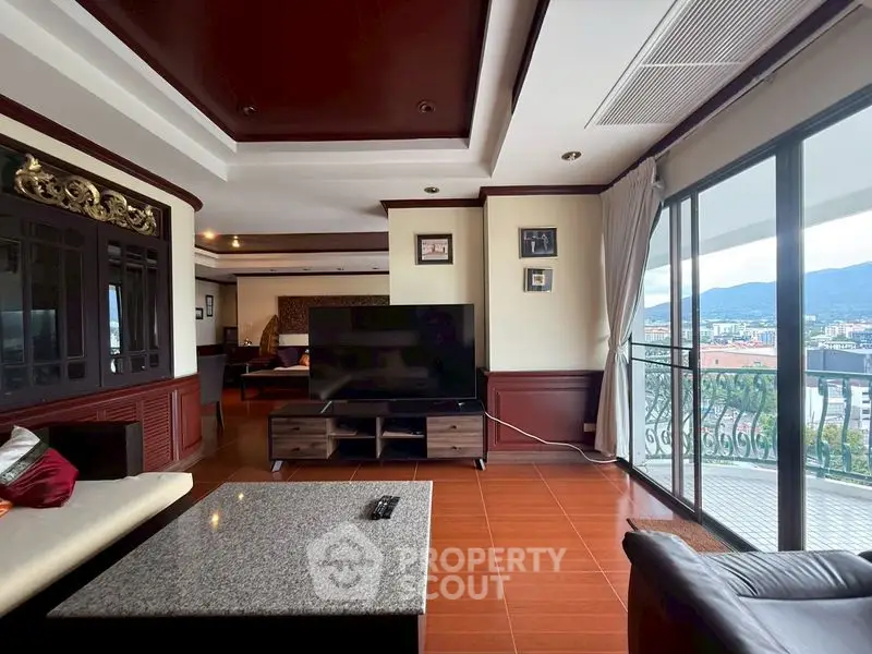 Spacious living room with large windows and stunning city view