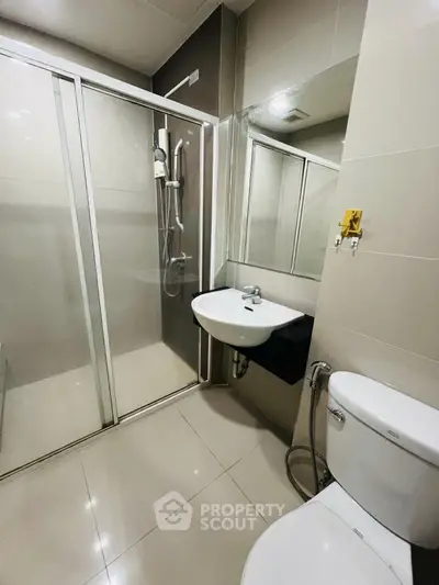 Modern bathroom with sleek shower and contemporary fixtures in a stylish real estate property.