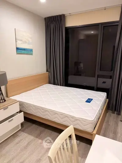 Modern bedroom with stylish decor and large window for natural light.