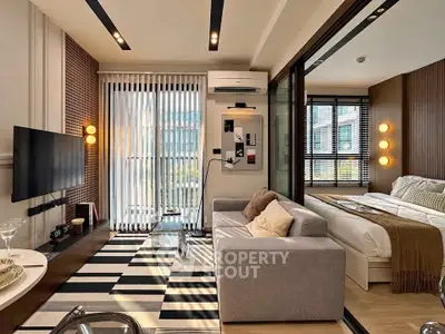 Modern living room with stylish decor and cozy bedroom in open layout apartment