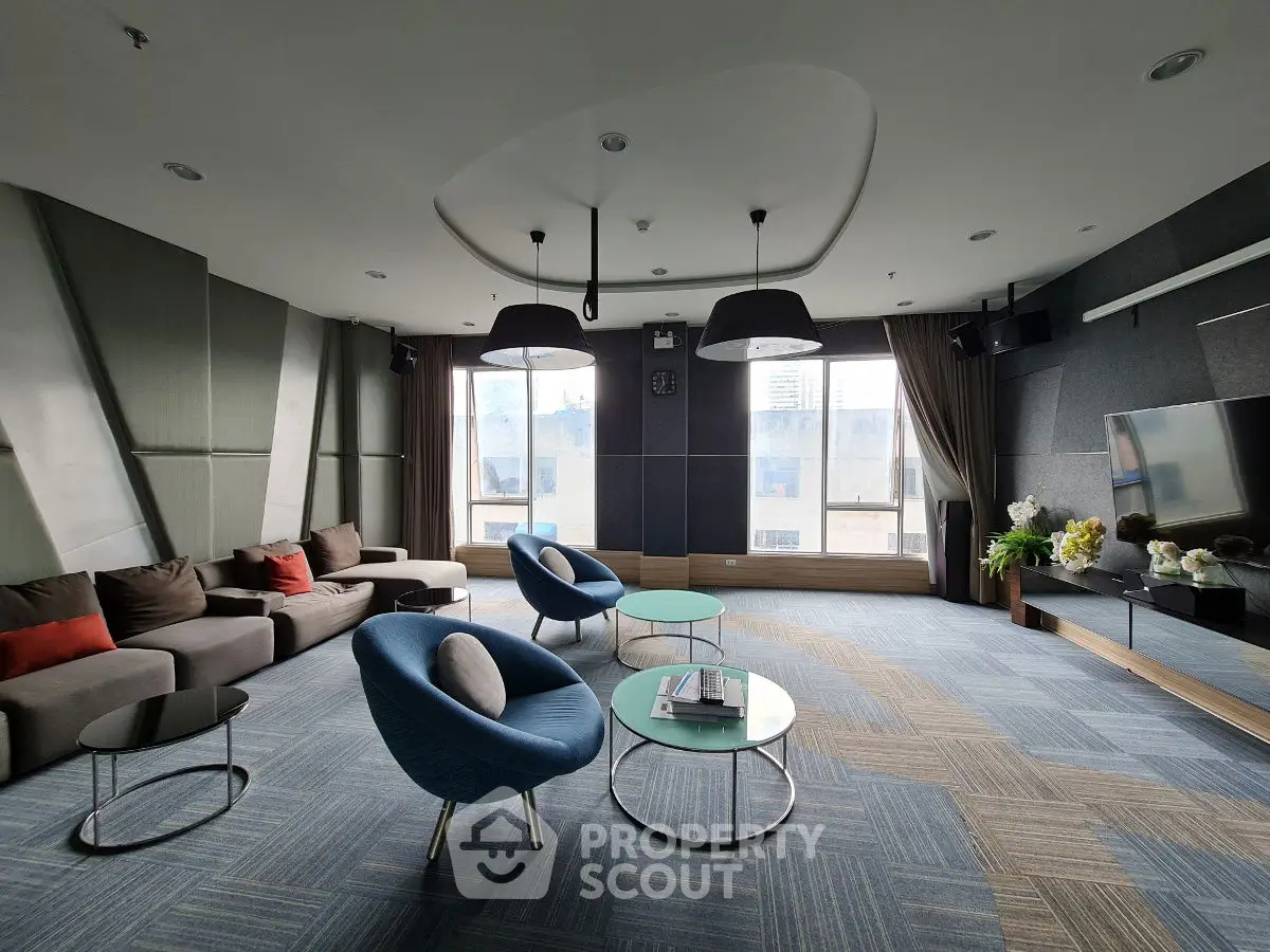 Luxurious modern living room with stylish furniture and large windows offering city views.