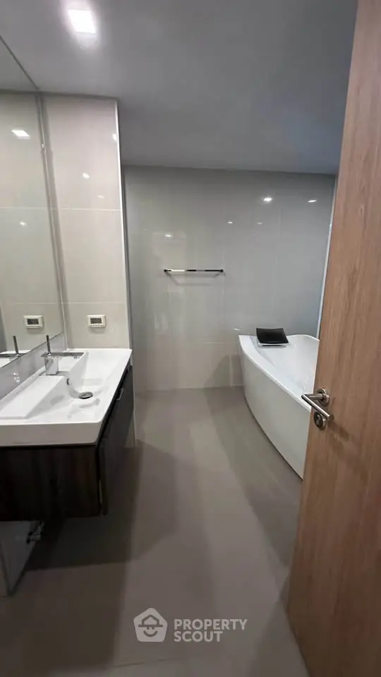 Modern bathroom with sleek design featuring a luxurious bathtub and elegant fixtures.