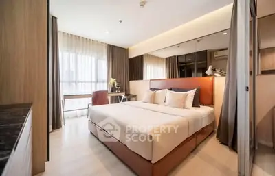 Modern bedroom with stylish decor and large window for natural light.