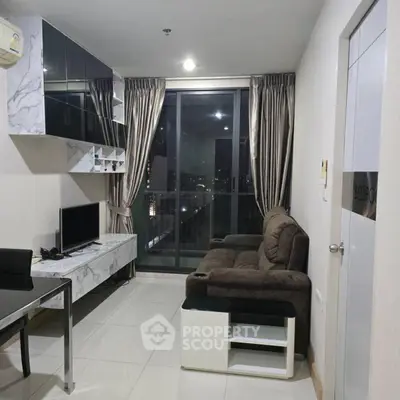 Modern living room with sleek marble accents and city view balcony in high-rise apartment.