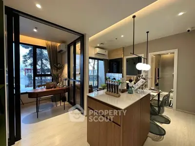 Modern open-layout kitchen and dining area with stylish decor and natural light.