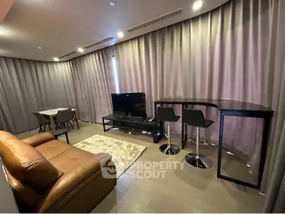 Modern living room with stylish furniture and ambient lighting, perfect for relaxation and entertainment.