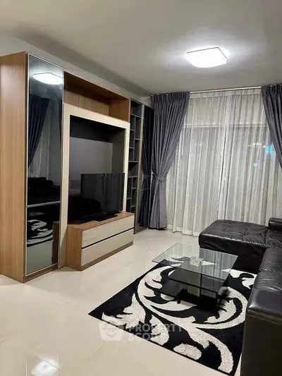 Modern living room with sleek furniture and large TV unit