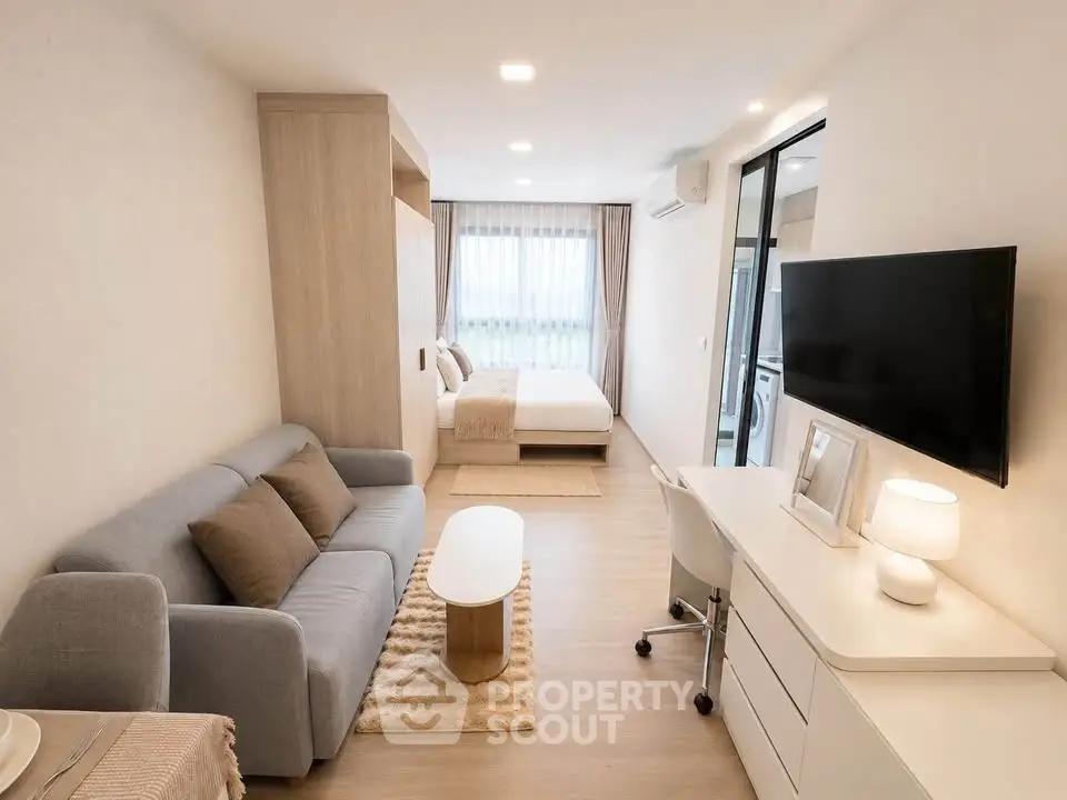 Modern studio apartment with cozy living area and stylish bedroom