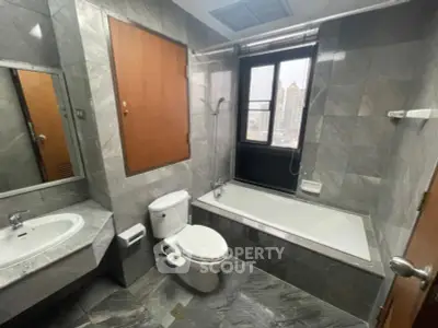 Luxurious marble bathroom with city view and modern fixtures