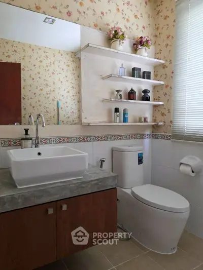 Charming bathroom with floral wallpaper and modern fixtures