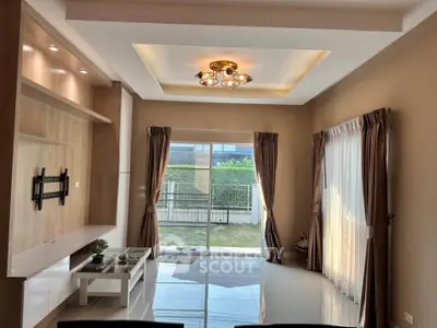 Elegant living room with modern lighting and garden view, perfect for relaxation and entertainment.