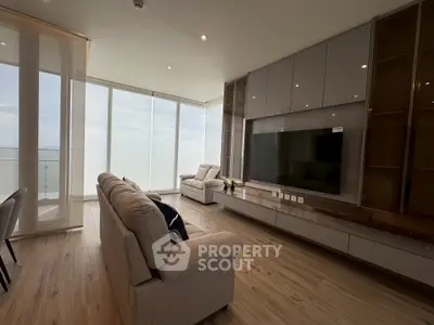 Luxurious living room with floor-to-ceiling windows and modern furnishings