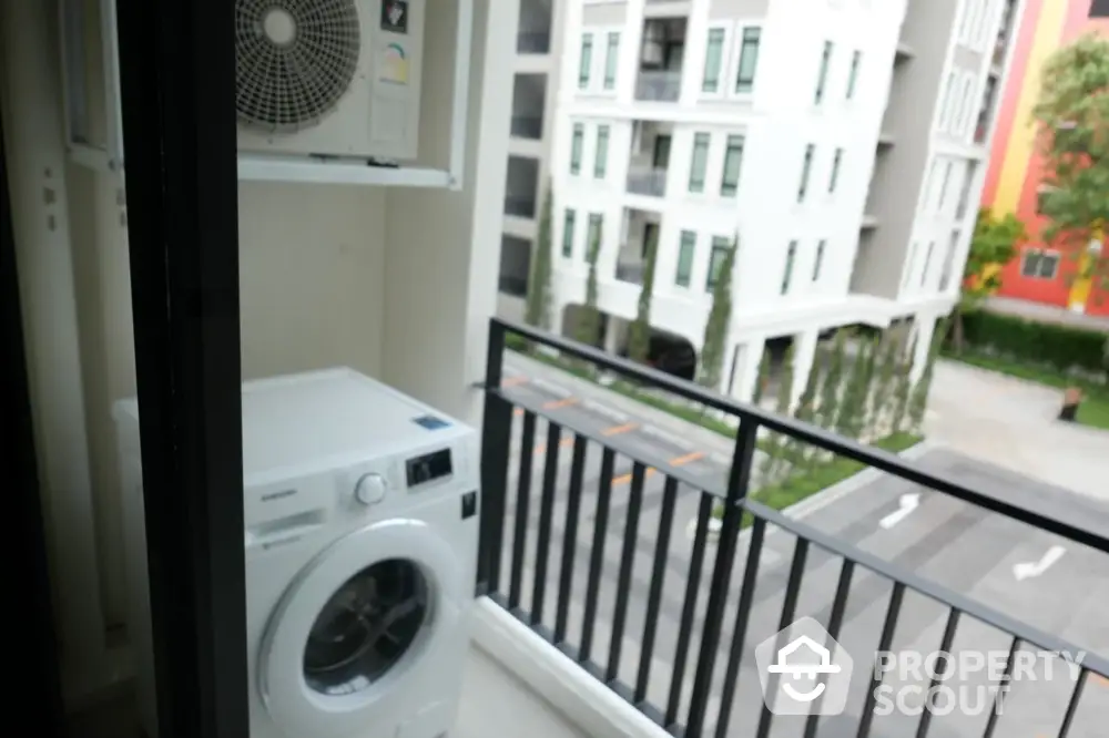 Modern apartment balcony with washing machine and city view