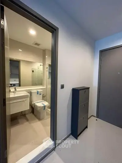 Modern bathroom entrance with sleek design and contemporary fixtures.