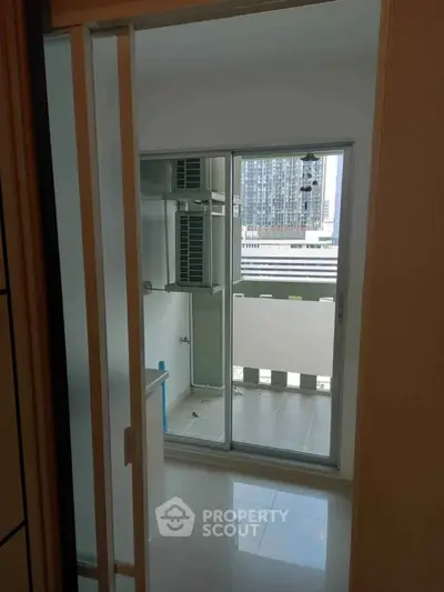 Modern apartment balcony with city view and sliding glass doors