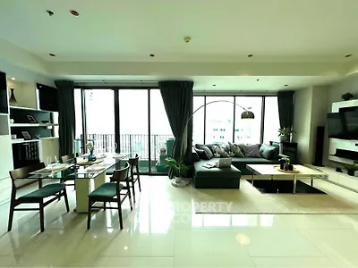 Spacious modern living room with elegant decor and large windows offering natural light.
