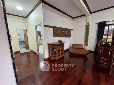 Charming living room with wooden floors and cozy seating in a stylish home.