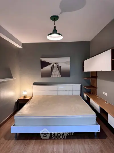 Modern bedroom with stylish furniture and serene wall art