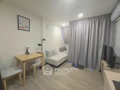 Modern living room with cozy sofa, wooden table, and stylish decor in a well-lit apartment.