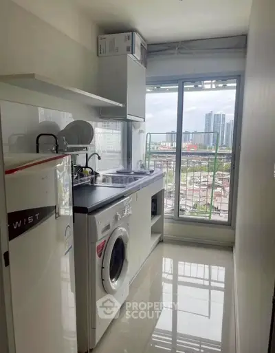 Modern kitchen with city view, featuring washing machine and sleek appliances.