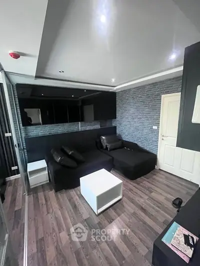 Modern living room with sleek black furniture and stylish decor