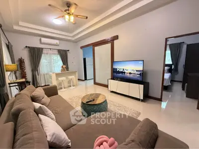 Spacious living room with modern decor and entertainment center