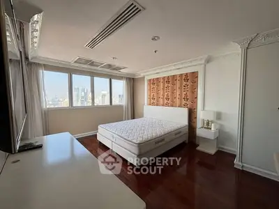 Spacious bedroom with city view and elegant decor