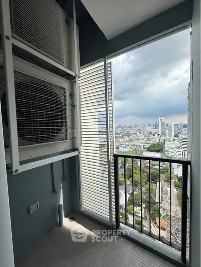 High-rise balcony with city view and air conditioning units, perfect for urban living.