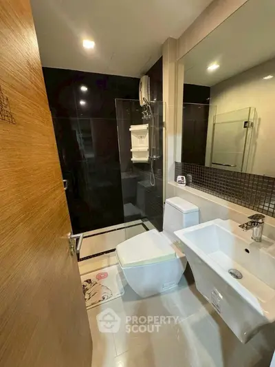 Modern bathroom with sleek fixtures and glass shower enclosure