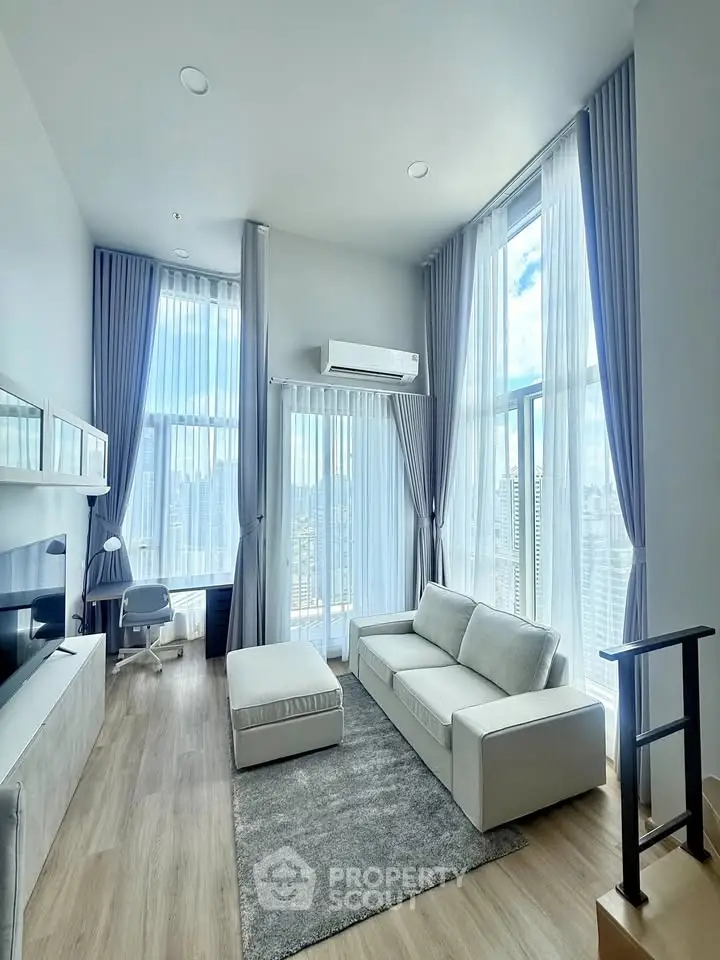 Luxurious high-rise living room with floor-to-ceiling windows and stunning city views.