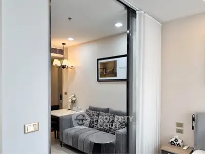 Modern living room with stylish gray sofa and elegant decor in a cozy apartment setting.