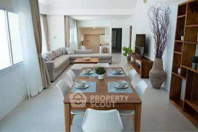 Spacious modern living and dining area with elegant decor and natural light.