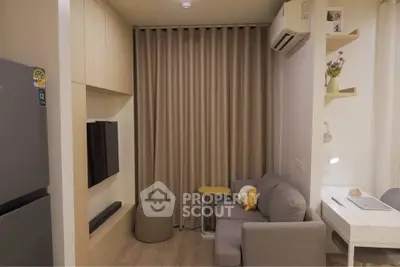Cozy modern living room with compact sofa, wall-mounted TV, and air conditioning unit.