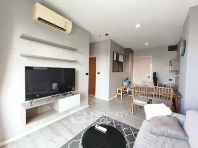 Modern living room with sleek furniture and wall-mounted TV in a stylish apartment.