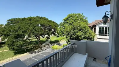 Charming balcony view with lush greenery and residential surroundings, perfect for relaxation and outdoor enjoyment.