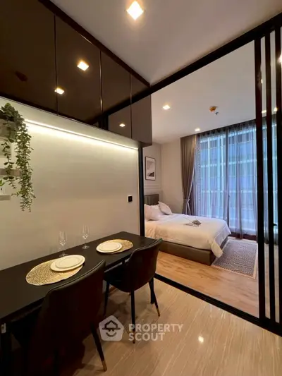 Modern apartment interior with dining area and cozy bedroom
