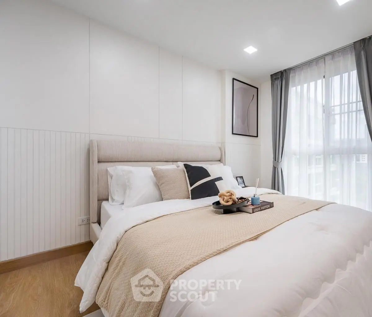 Elegant bedroom with cozy bedding and natural light