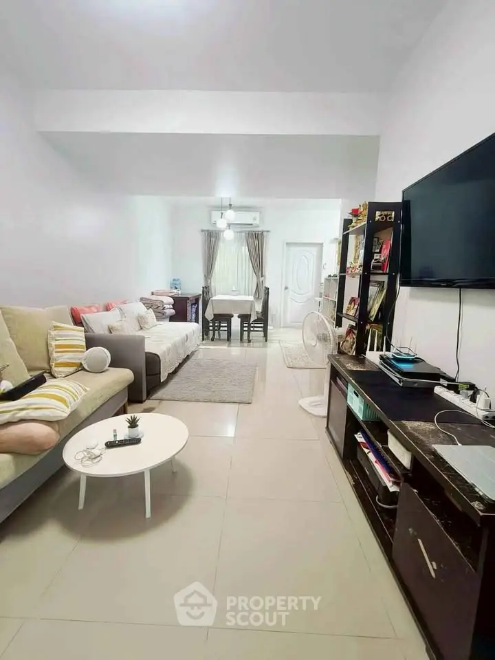 Spacious living room with modern decor and entertainment setup, perfect for relaxation and gatherings.
