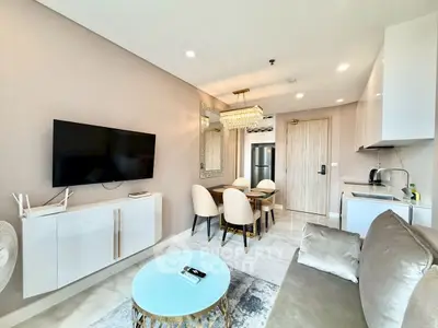 Modern living room with elegant dining area and sleek kitchen in open layout