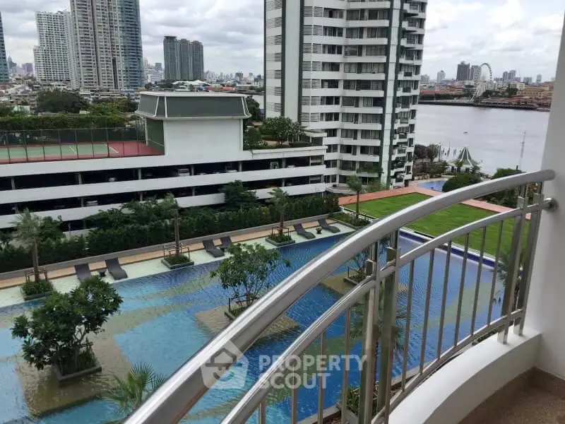 Stunning balcony view overlooking a luxurious pool and cityscape.