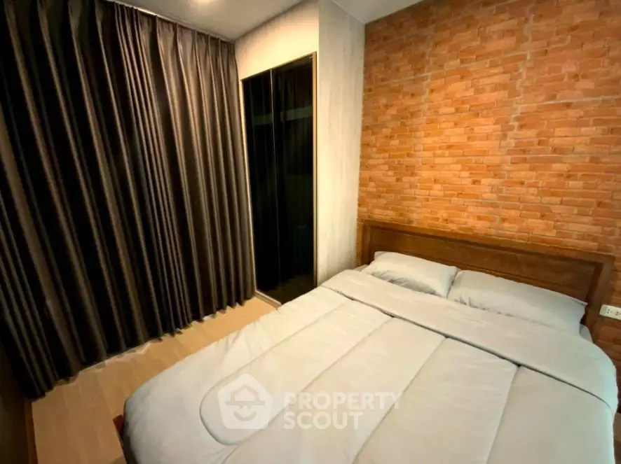 Cozy bedroom with brick accent wall and modern curtains