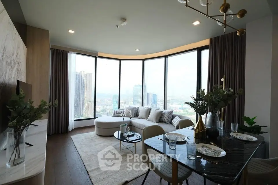 Luxurious high-rise living room with panoramic city views and elegant decor.