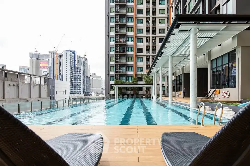 Luxurious high-rise apartment with stunning pool and city views, perfect for urban living.