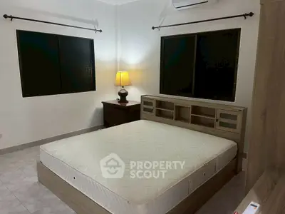 Spacious bedroom with modern furniture and ambient lighting